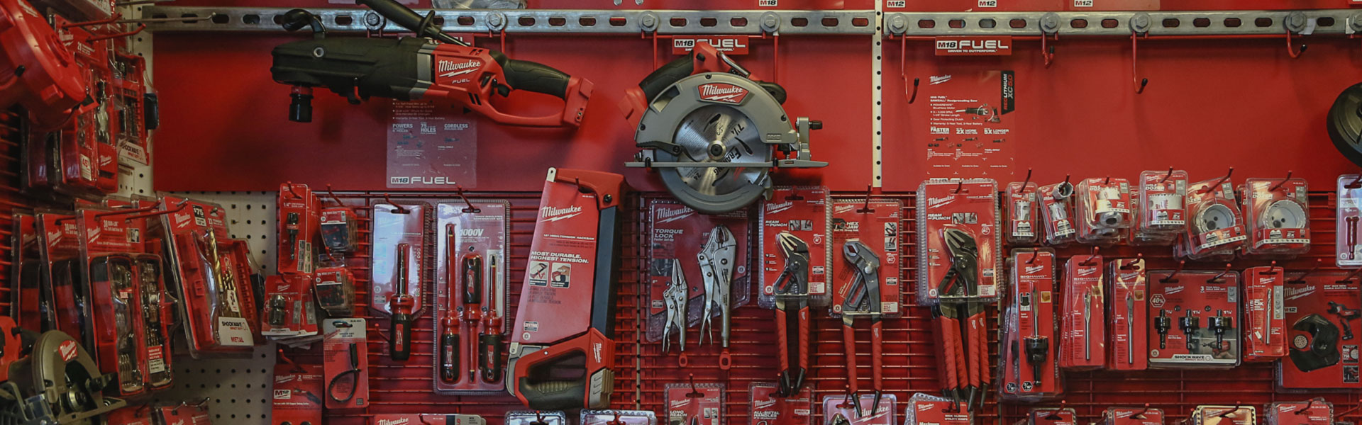 A red wall with many different tools on it
